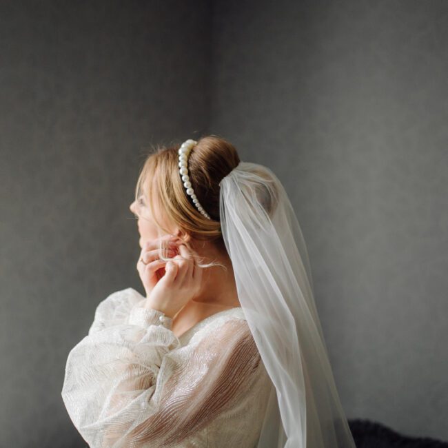 Bride with a long cathedral veil in a wedding portrait